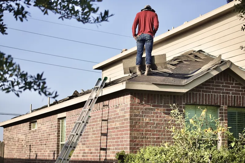 Professional roofer working on a residential roof in Hyndman